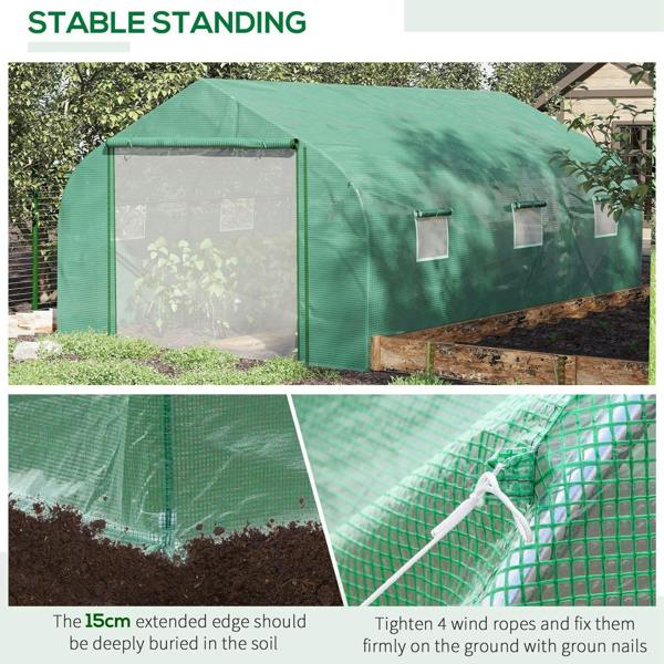 Green walk-in greenhouse standing outdoors with mesh window panels and zip door