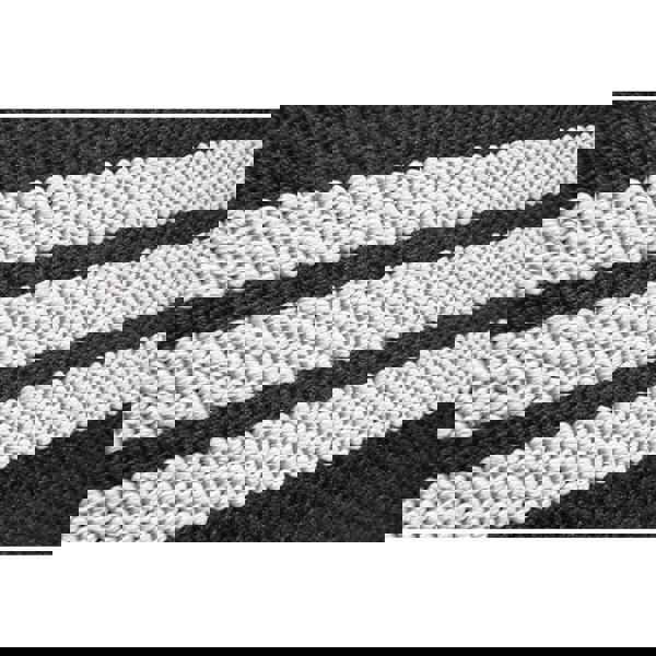 Close-up of black and white striped fabric pattern from the adidas wrist wraps