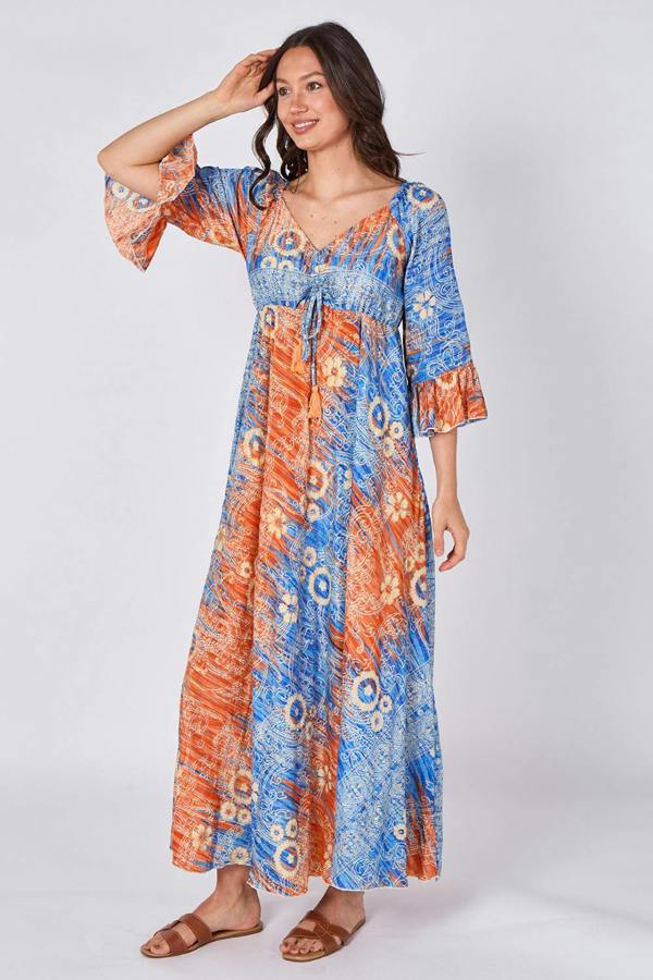 Woman wearing a colorful patterned dress on a white background