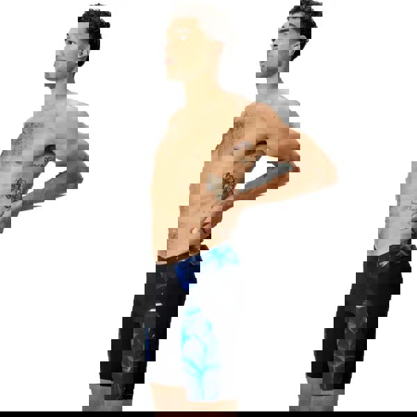 Black and vibrant blue Speedo Endurance+ Max Compress swim trunks with glowing leaf pattern