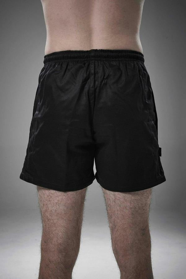 Man wearing black Optimum Auckland rugby shorts, back view on grey studio background - Optimum