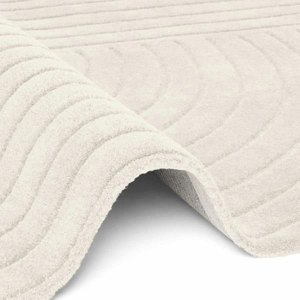 Close-up of a textured beige bath mat on a white background