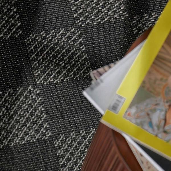Close-up of a book with a colorful cover on a textured black surface