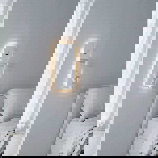 white bedroom wall light with reading light mounted on the wall next to the bed in a white room