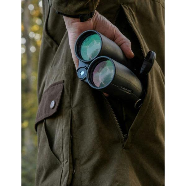 Close-up of Deerhunter Eagle Jacket side pocket with binoculars, showing practical storage for hunting and shooting