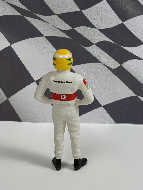 a toy figure of a race car driver