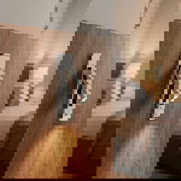 white recessed bedroom reading lamp mounted on a wall in a hotel room