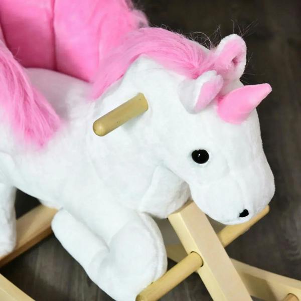 Close-up of white plush unicorn head with pink mane and wooden rocker handles