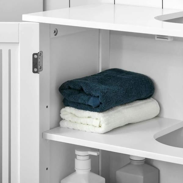 White under sink cabinet open shelf with folded towels and toiletry bottles