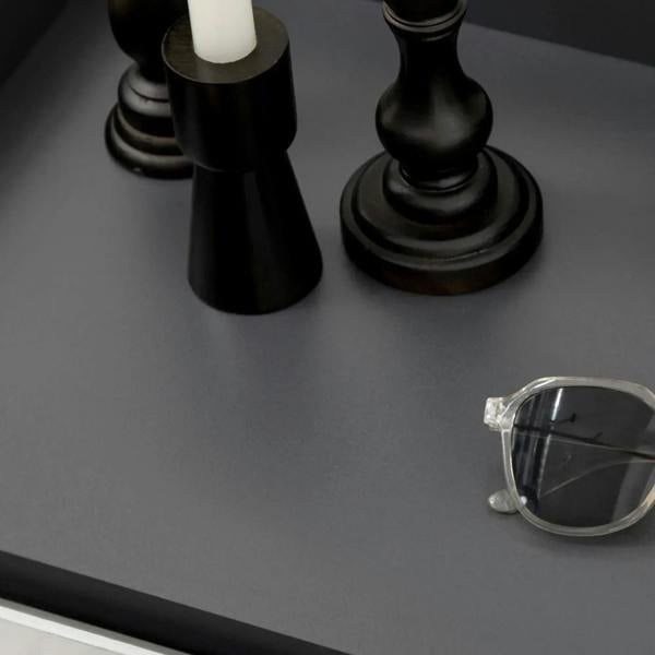 Matte grey cabinet top panel detail with corner hardware