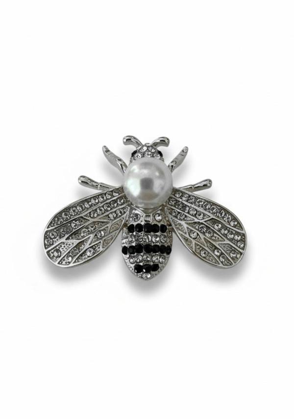 Bee brooch with pearl and gemstone details on a white background