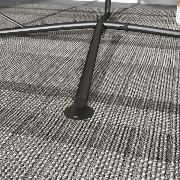 Black hammock chair stand base with circular foot pad on woven rug