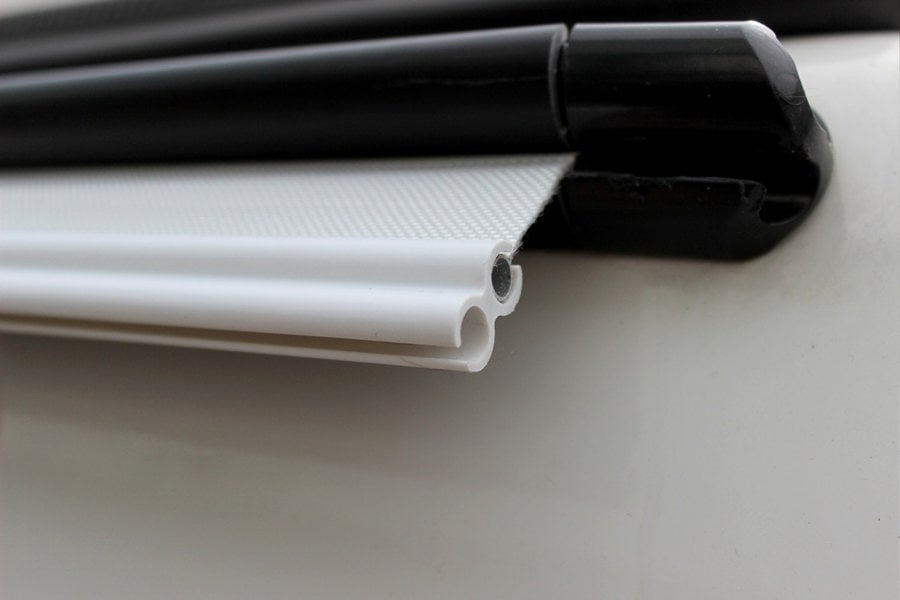 The OLPRO 6-6mm Awning Drive Away Kit attached to an awning rail on a campervan awning, showing the Kador strip and figure of 8.