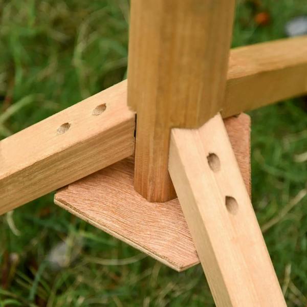 Wooden feeding station perch support with drilled holes and angled brace