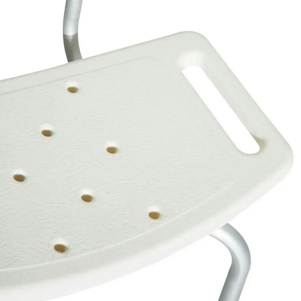 White shower stool seat close-up with textured anti-slip surface and drainage holes.