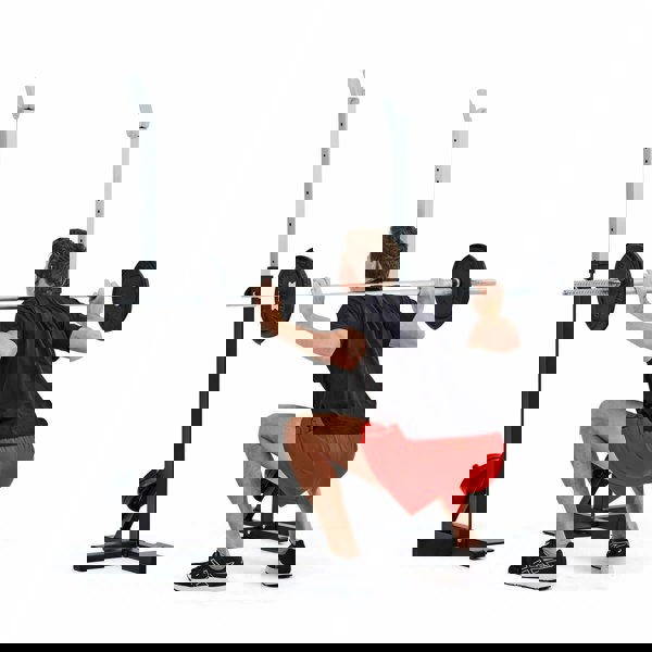 Man performs squats with the York Squat Rack