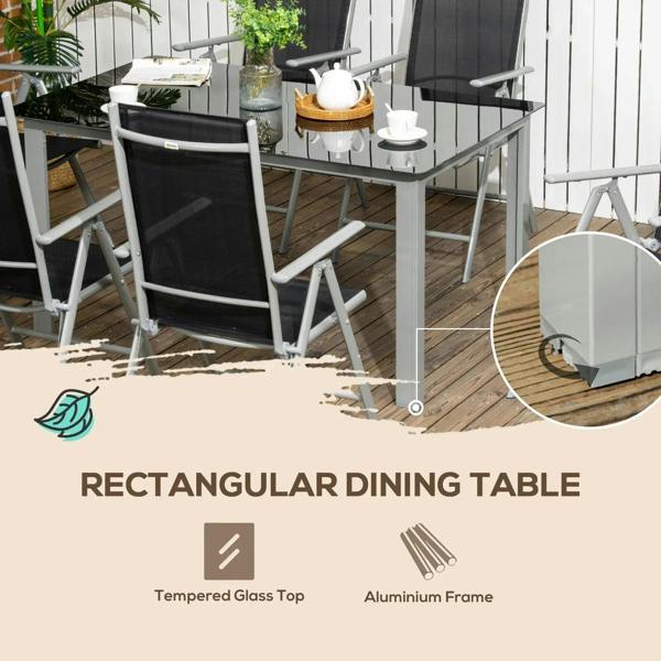 Rectangular dining table with tempered glass top and aluminum frame, paired with black chairs