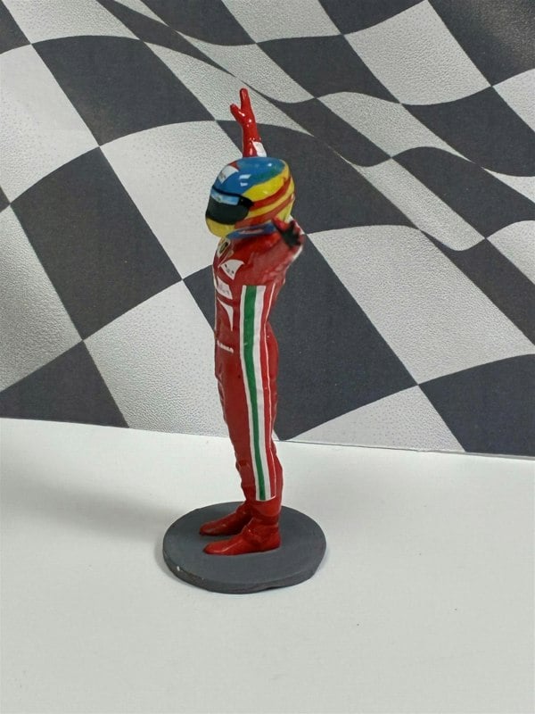 a toy figurine of a race car driver