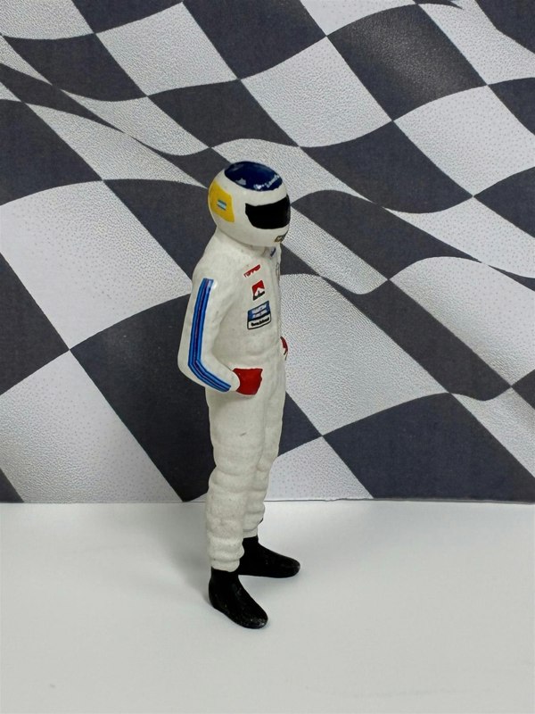 a toy figure of a man wearing a helmet and a helmet