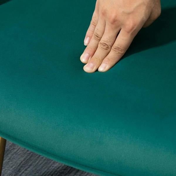 Green velvet upholstery fabric with hand pressing, showing plush padded texture