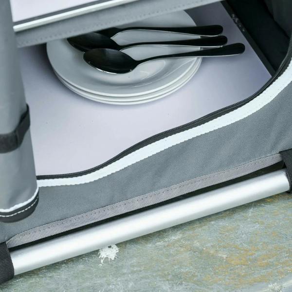 Grey camping cupboard base with fabric trim and zipper edge detail, aluminum support bar.