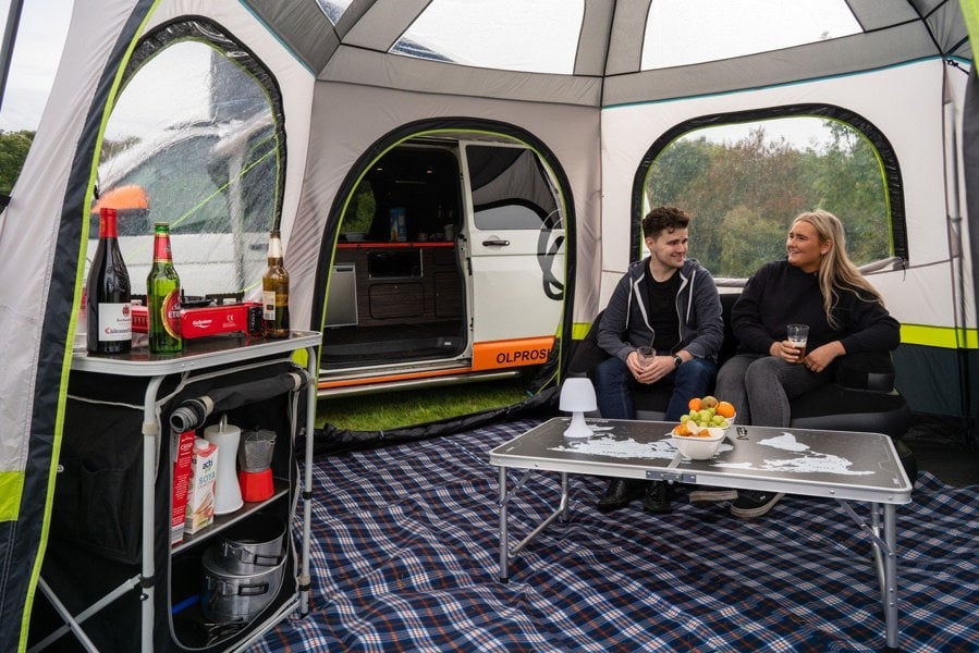 An adult couple inside of the Hive Campervan Awning Fibreglass Poles - with Sleeping Pod from OLPRO.