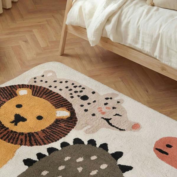Children's rug with animal designs on a wooden floor