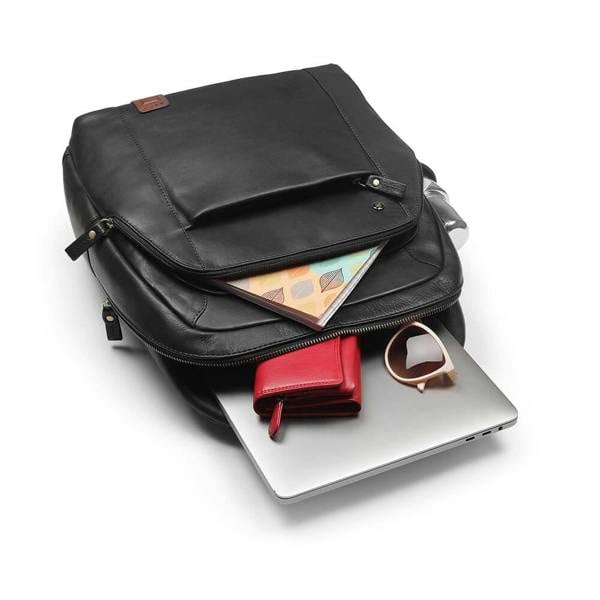 Black leather backpack with laptop, wallet, and sunglasses on a white background