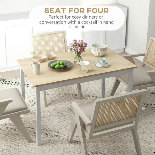 Dining table for four with natural wood top and white legs, styled with dishes