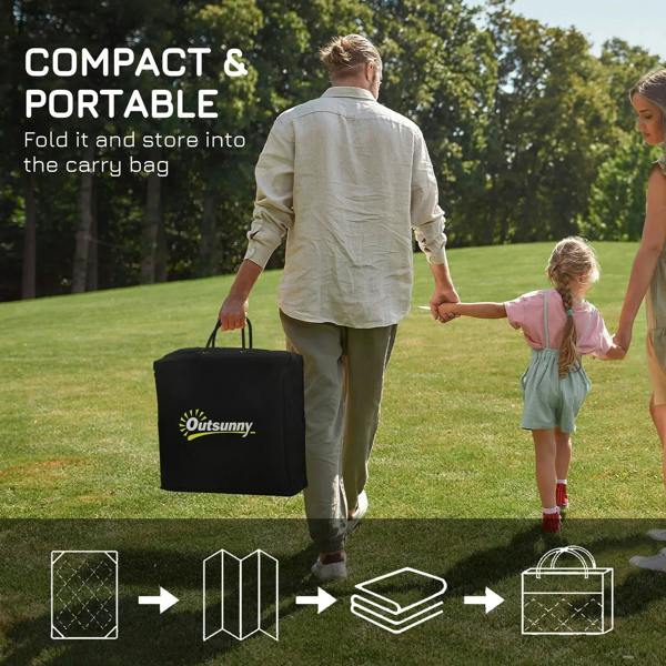 Portable outdoor rug carry bag, shown being carried outdoors on grass