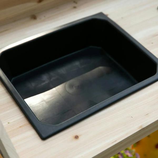 Close-up of black removable plastic sink basin set into a natural wood bench