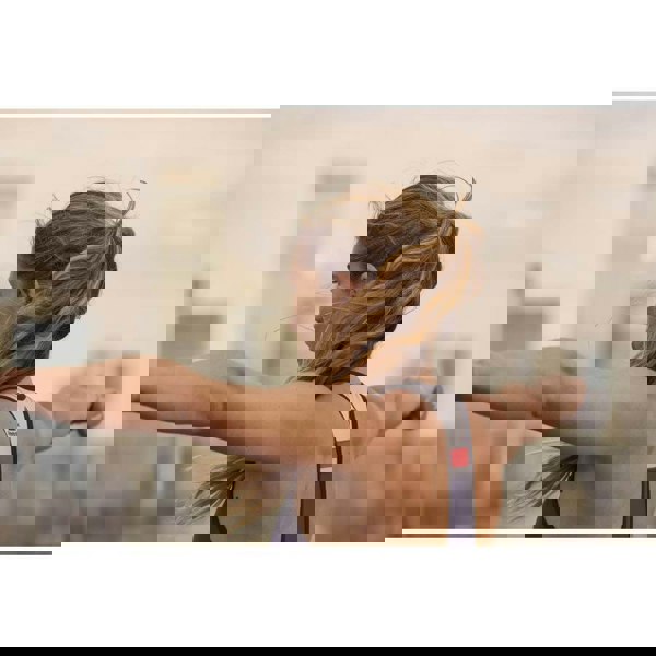 Woman exercising using Reebok 1kg Dumbbells