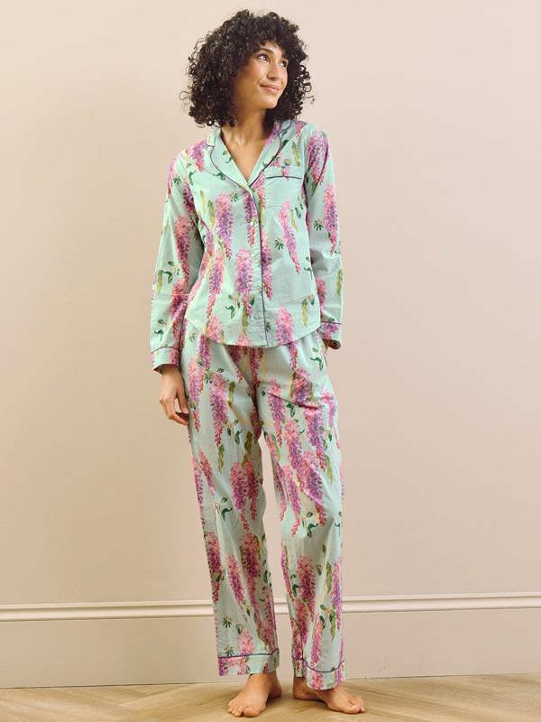 model wears wisteria print long traditional pyjama set. 