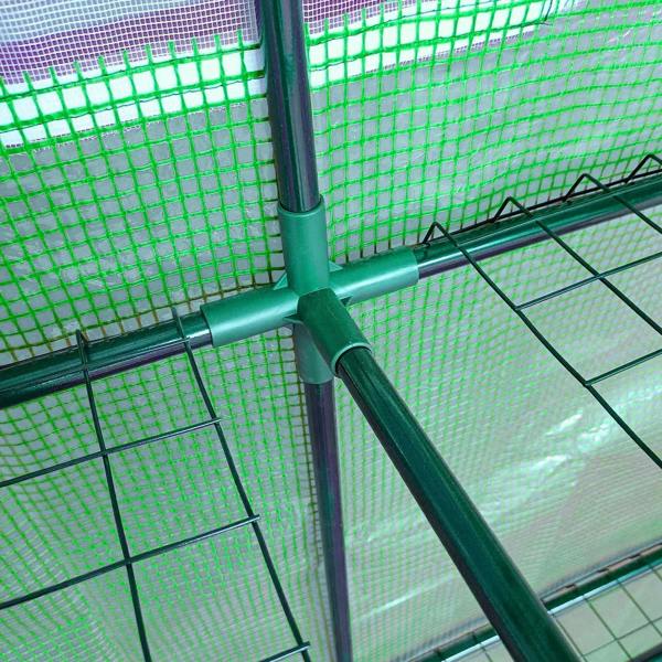 Close-up of green steel frame bar and grid shelving inside the greenhouse