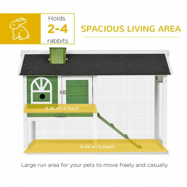 Green and white rabbit hutch with black roof panel and sloped ramp
