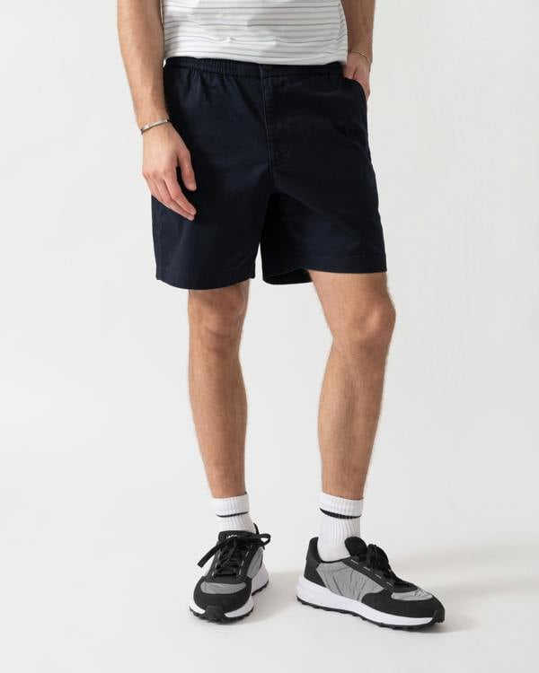 studio shot of a model wearing Lacoste Relaxed Fit Mens Stretch Cotton Shorts in Abysm HDE