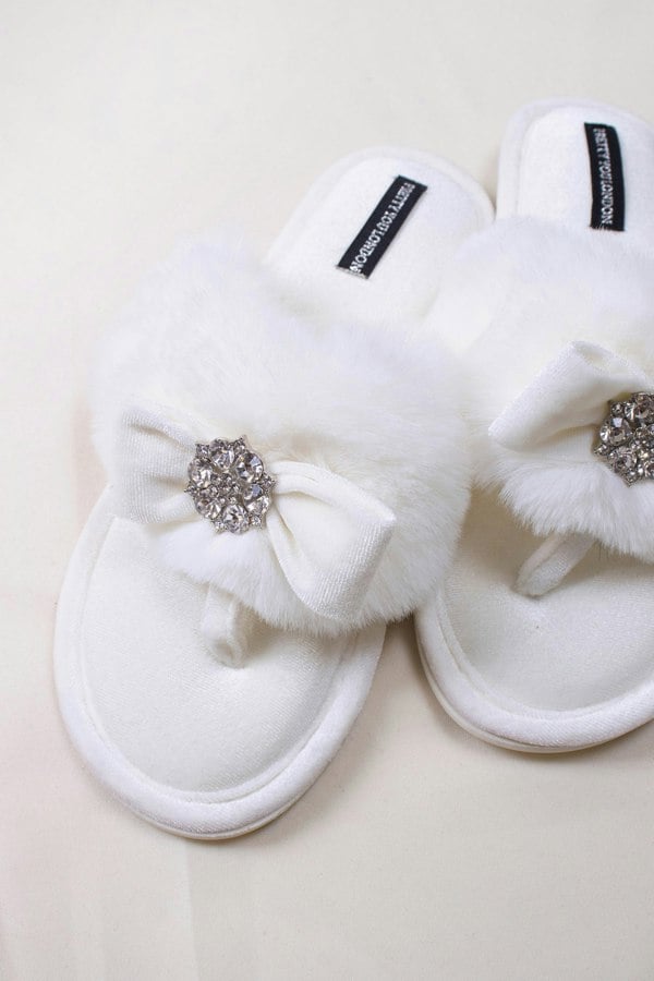 Amelie women's toe post slippers in cream with a premium velvet bow and diamante embellishment atop a plush faux fur band from Pretty You London