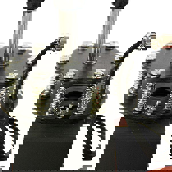 Close-up of the PixMax Cap Heat Press & Printer showing metal springs, a sturdy base, and a heat element for precise printing