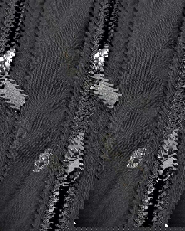 Lambretta Mens Padded Hooded Classic Badge Parka, close-up of black fabric with metal zippers and buttons.