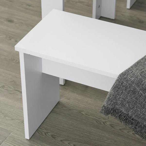 Close-up of white bench/tabletop corner with smooth finish and straight support legs