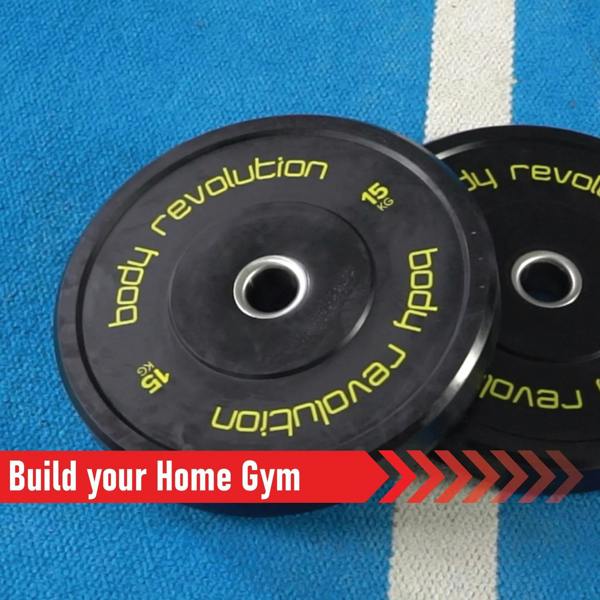 Black Olympic bumper plates with bright yellow lettering, showcasing 15 kg weight, ideal for home gym setups on a blue mat