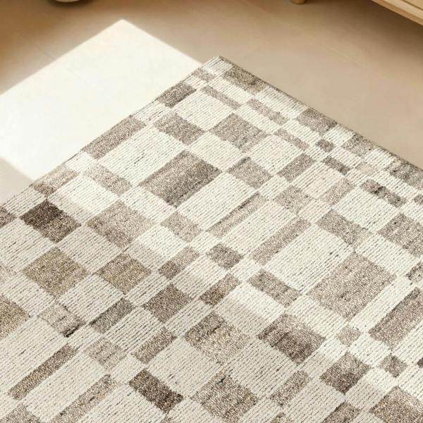 Checkered patterned rug on a wooden floor