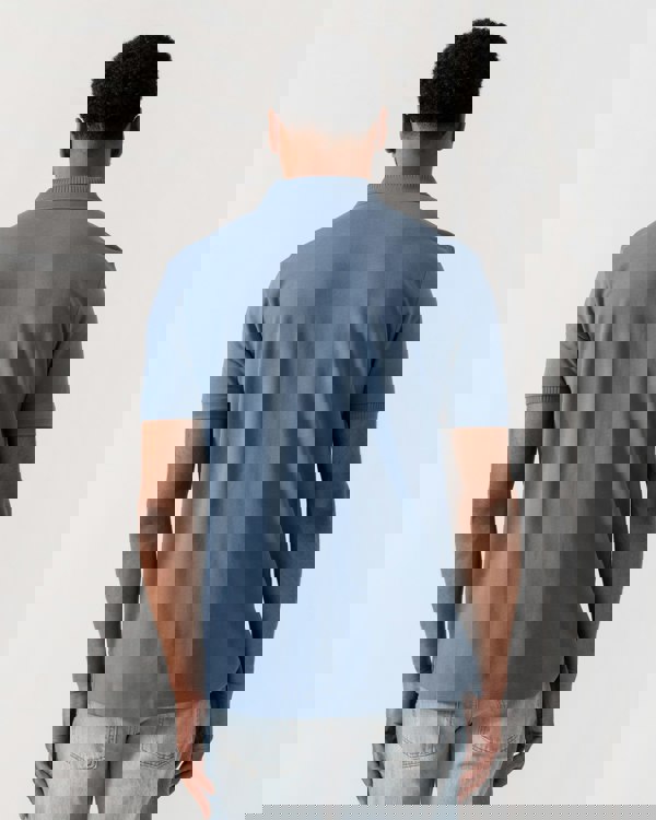 Model wearing HUGO Dereso222 Mens Cotton Piqué Slim-Fit Polo Shirt with Logo Label in Open Blue 496 - Back