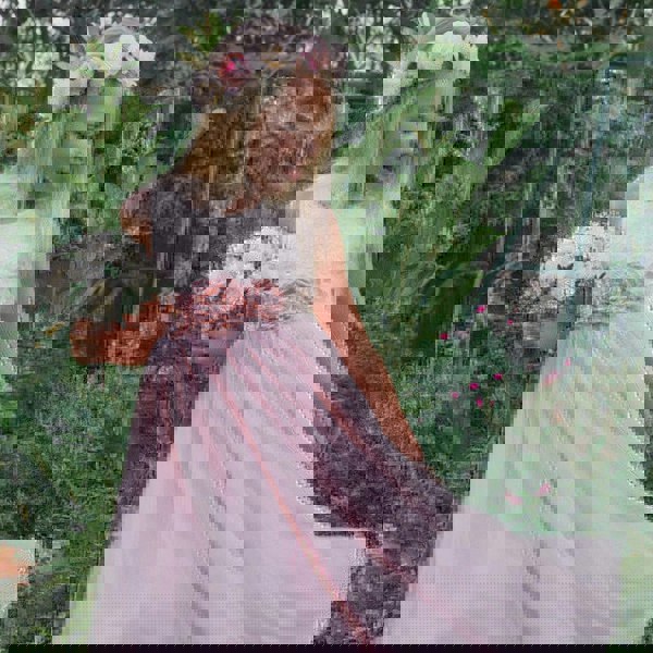 girl in pink party dress with bouquet