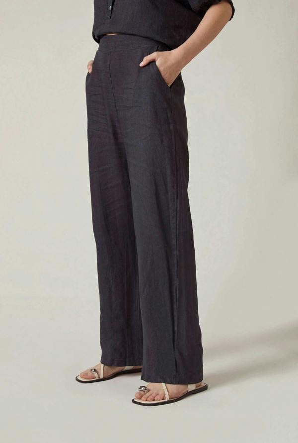 Front view of the Relaxed Navy Linen Trousers by James Lakeland worn by model