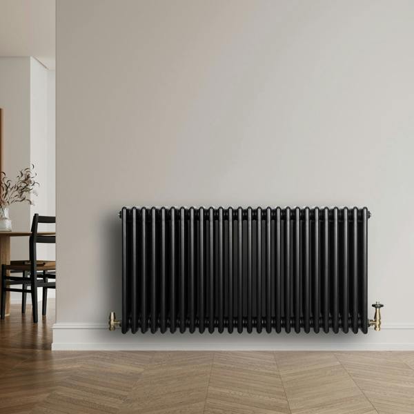 Traditional black 4 column radiator, 600 x 1190mm, featuring a sleek design and smooth finish, mounted on a light wall in a modern room