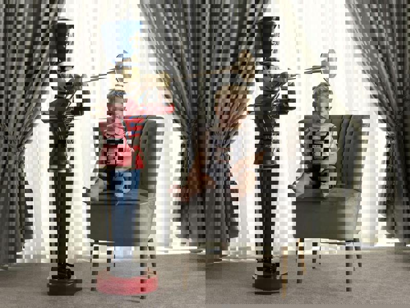 Baby boy wearing sailboat smocked dungarees styled with red piping peter pan collar shirt