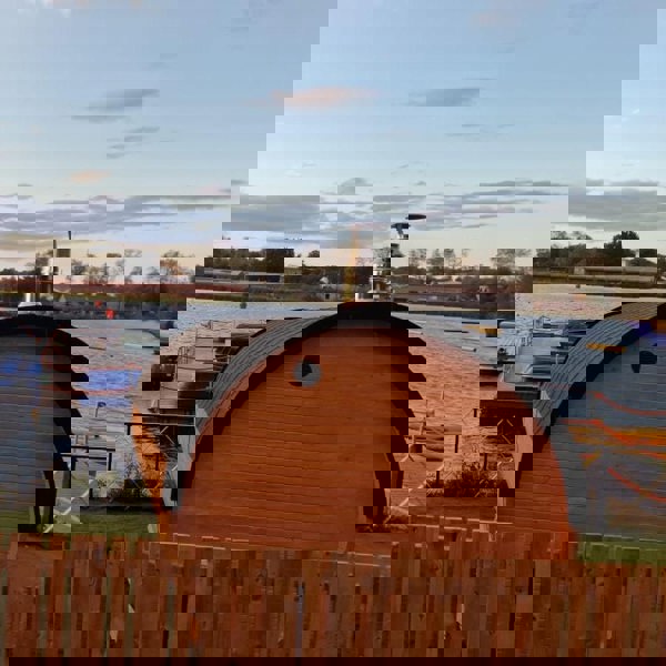 Wooden barrel sauna by the lake