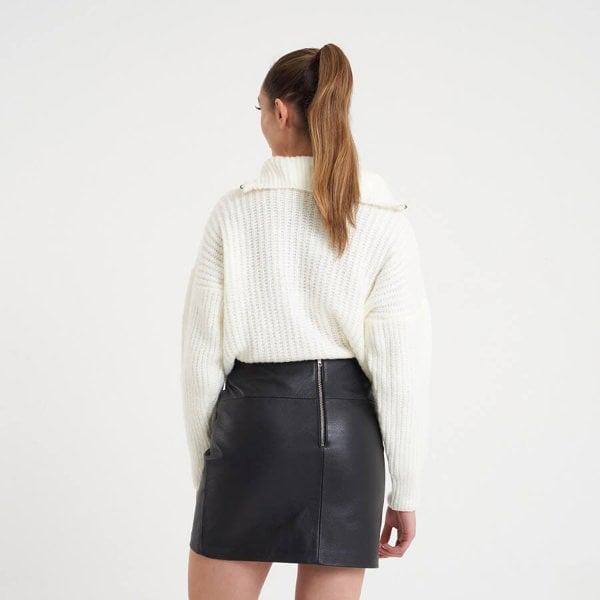 Image displays the back of a model wearing the Barneys Originals real leather mini skirt to display the zip on the back of the waistline.