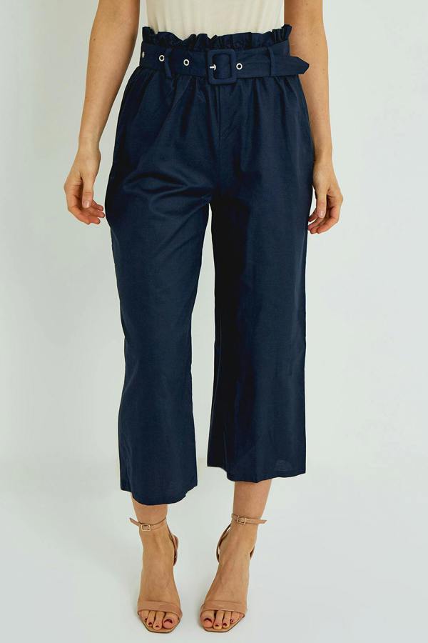Navy blue paperbag waist pants worn by a person on a white background
